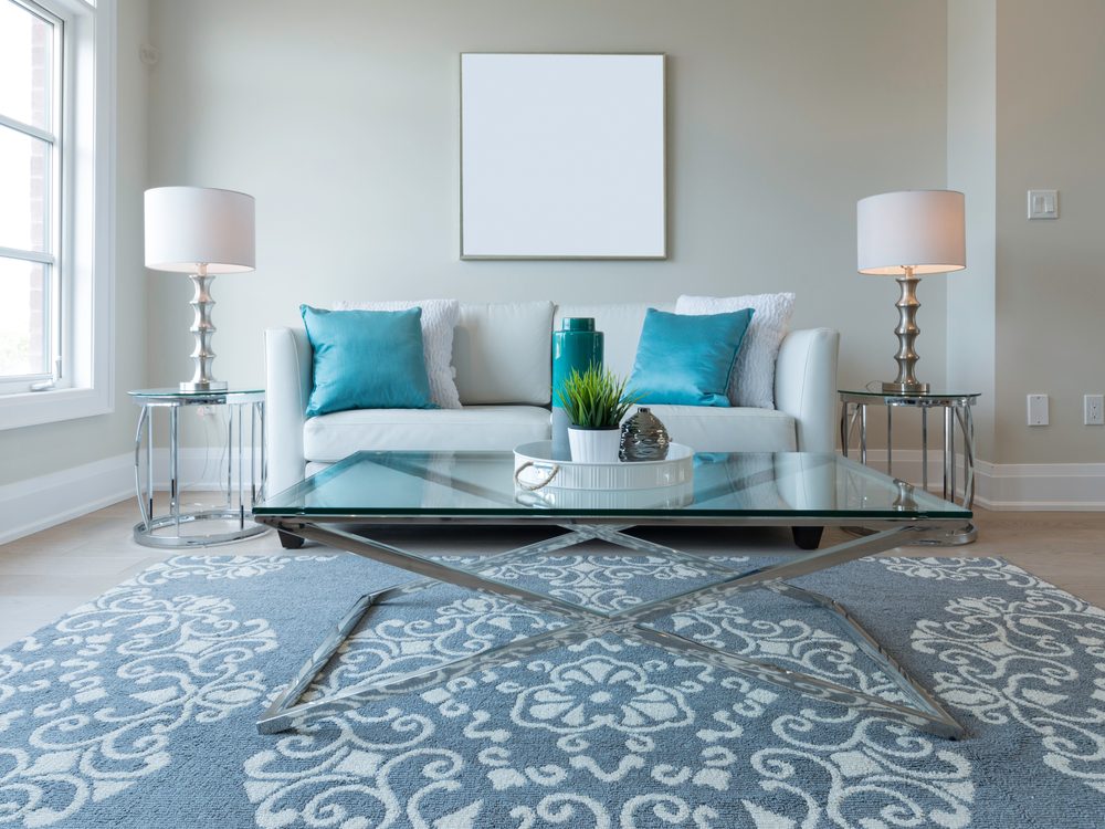 Bright, tidy living room with teal accents