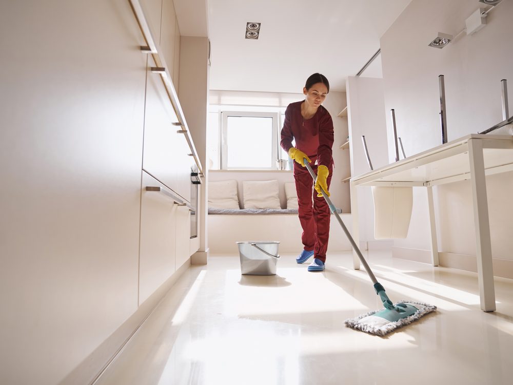 A professional Neat Freaks cleaner mopping a bright, spotless room